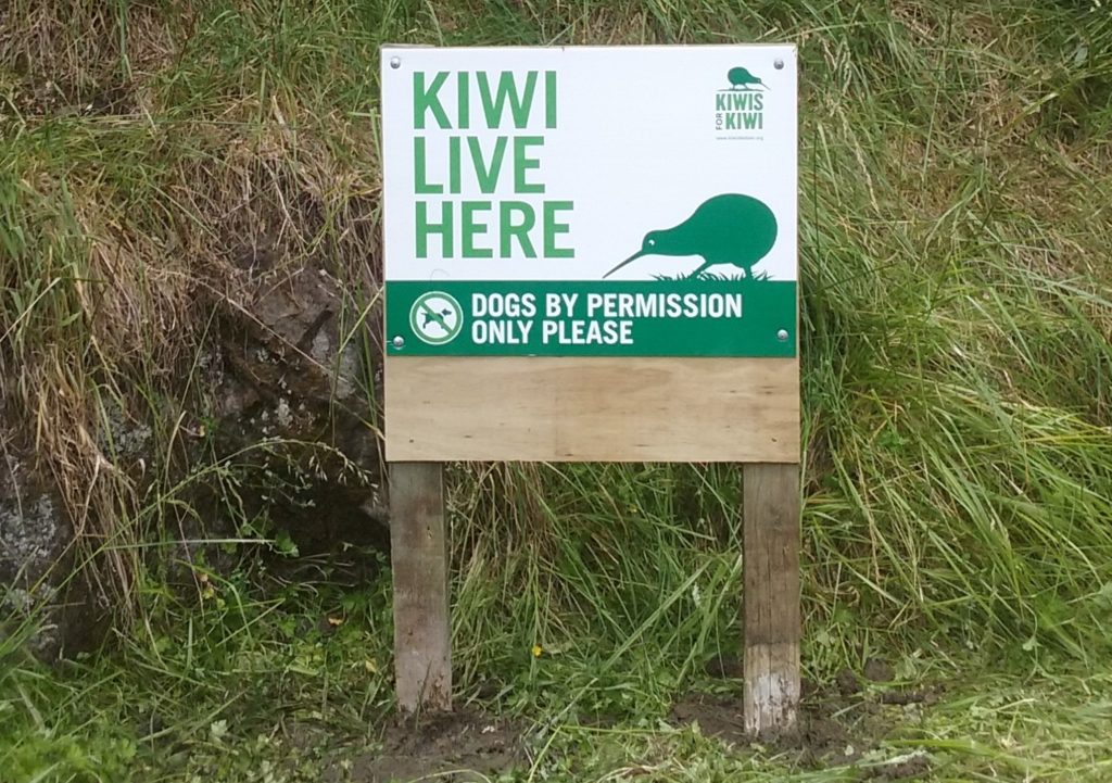 A sign tells people "kiwi live here" and tells them "dogs by permission only please"