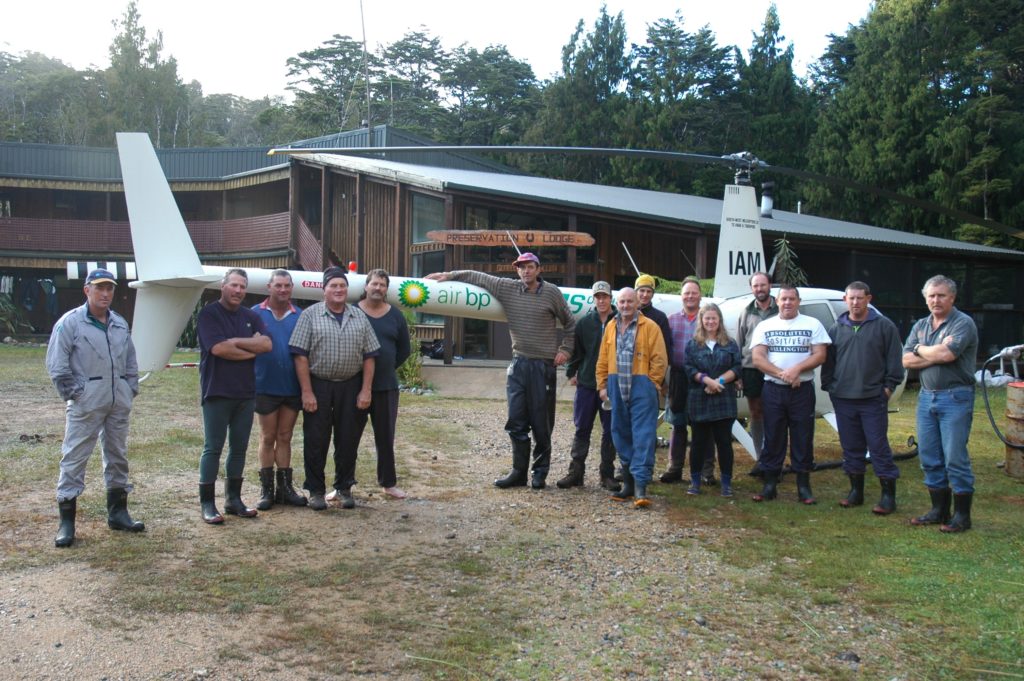 A group in front of a helicoptor