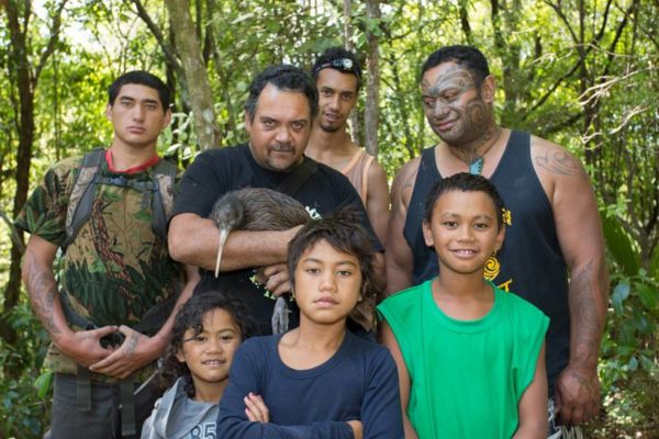 Ian and some community members with a kiwi