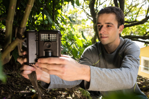 Researcher Victor Anton checks a remote camera.