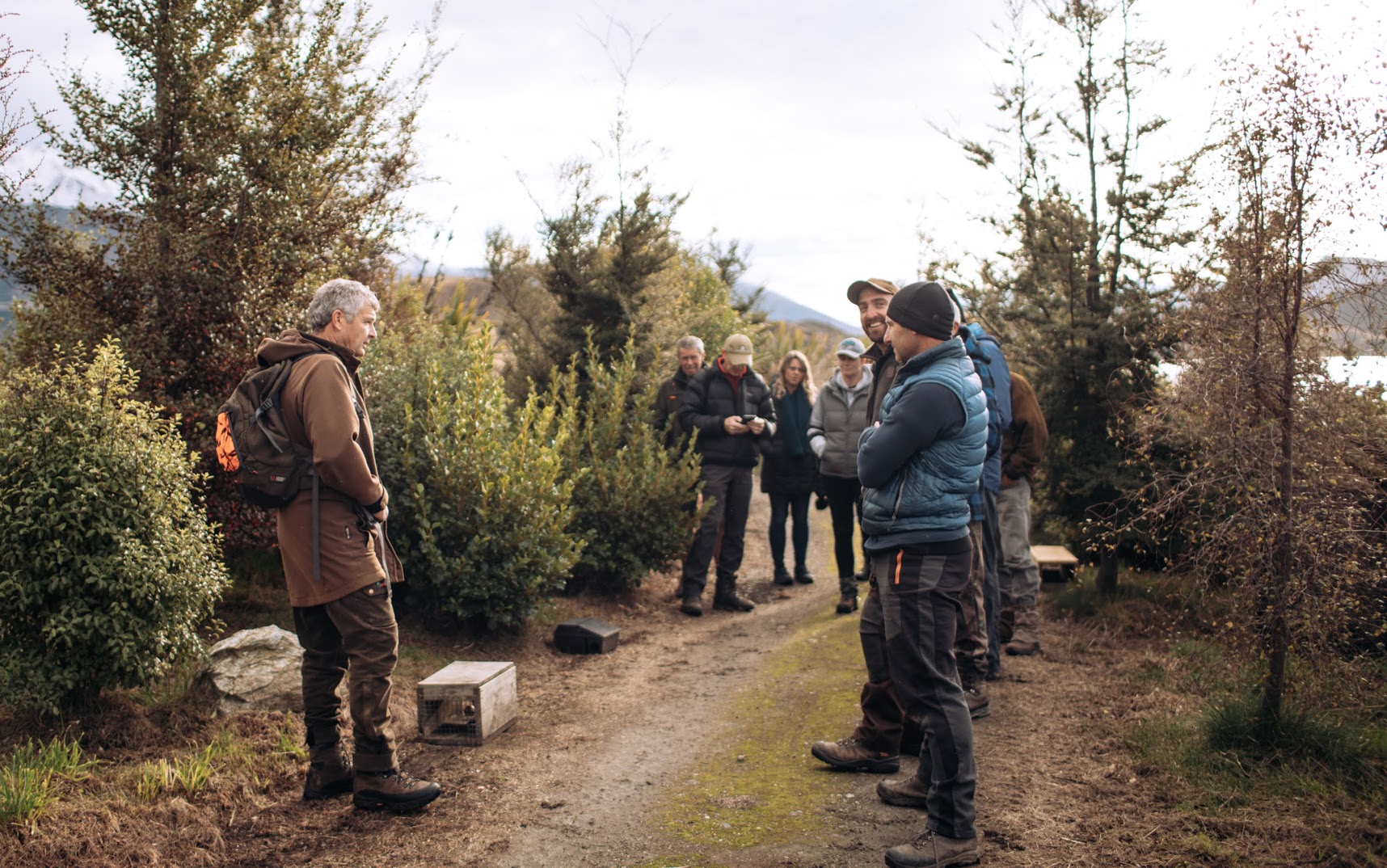 A group of people stand around a trap in Wanaka