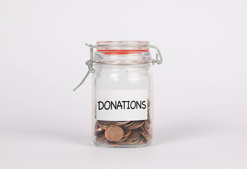 Jar with coins and donate label, be aware of donation laws 