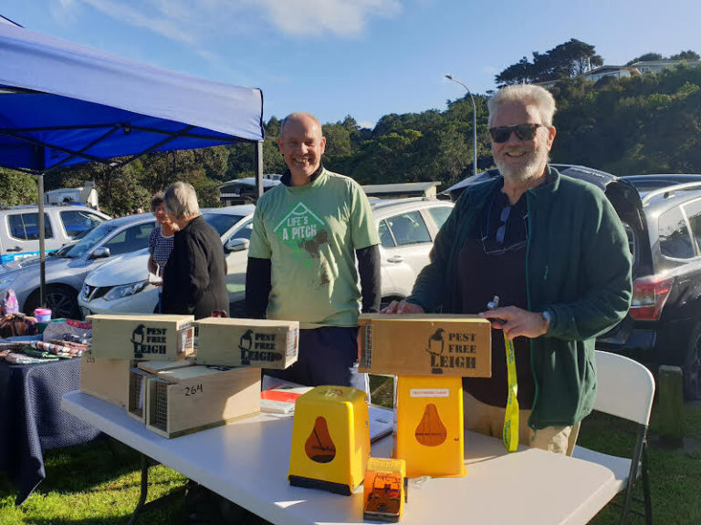 Two men with traps at a stall