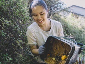A young woman composting