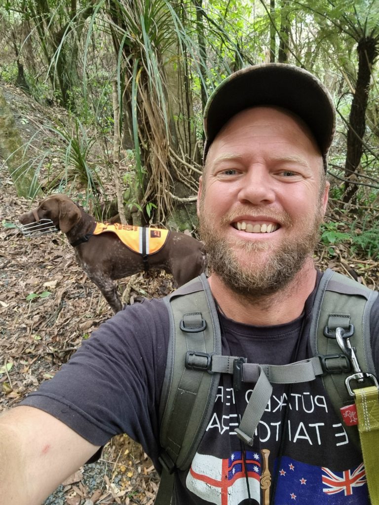 A selfie of both Brad and his dog out doing conservation work in the bush