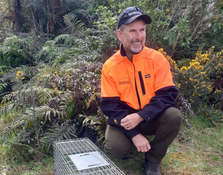 John next to a live catch trap