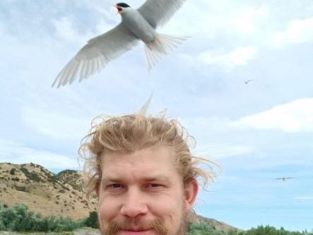 Keegan with a tern flying in the background