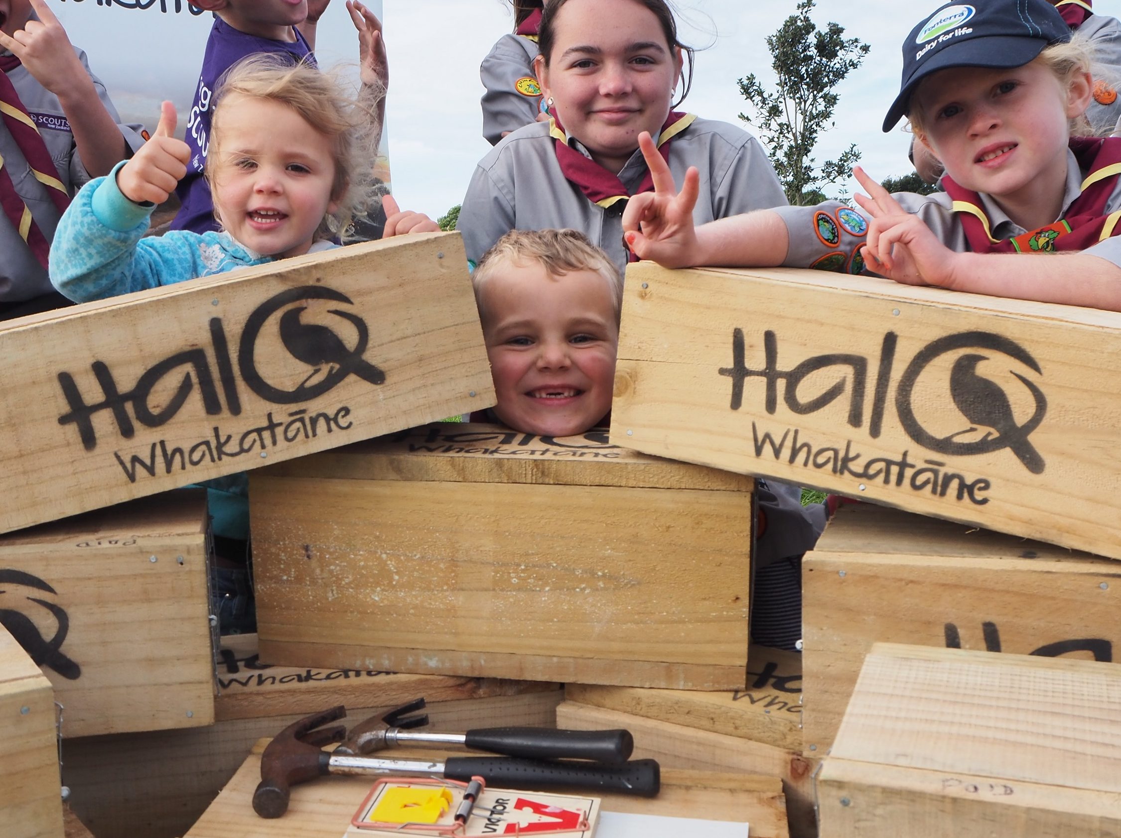 A group of kids with trap boxes doing peace signs