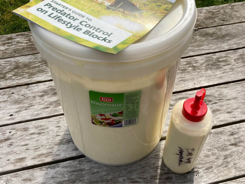 A big bucket of mayonnaise and a small squeezable container.