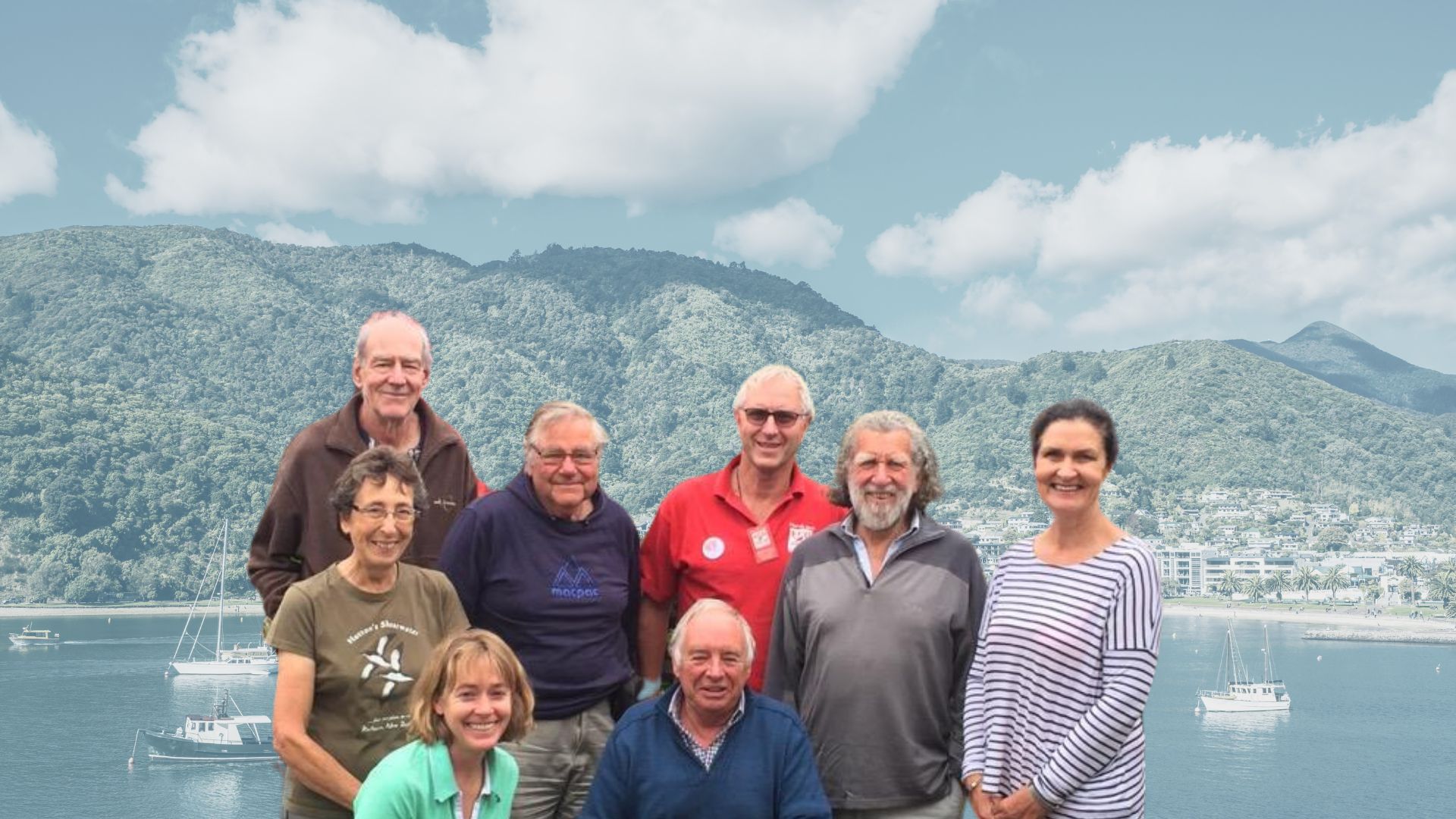 A group of people looking at the camera with the Marlborough Sounds in the background.