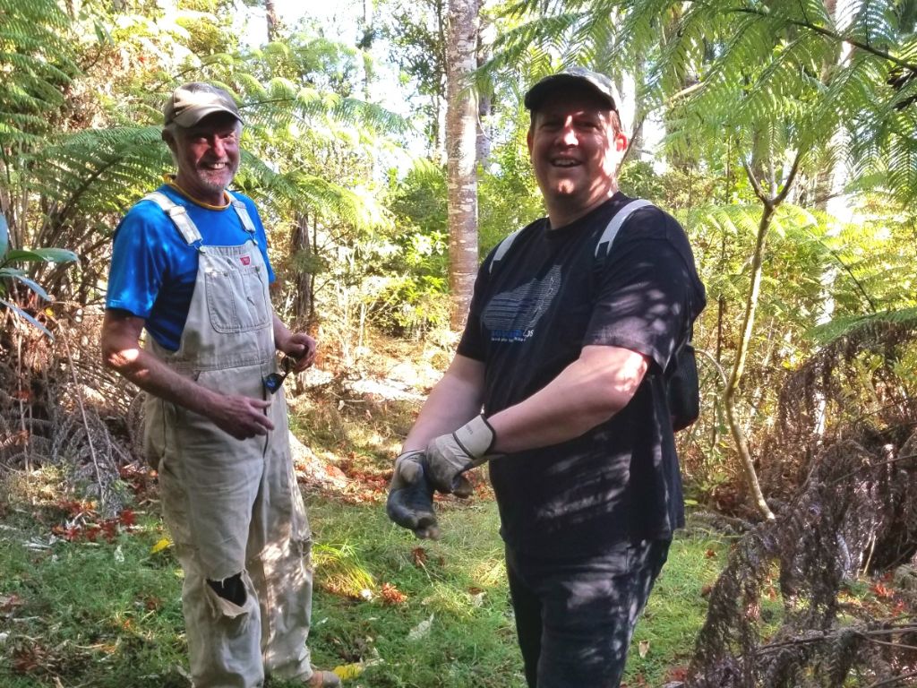 Two men standing in the bush