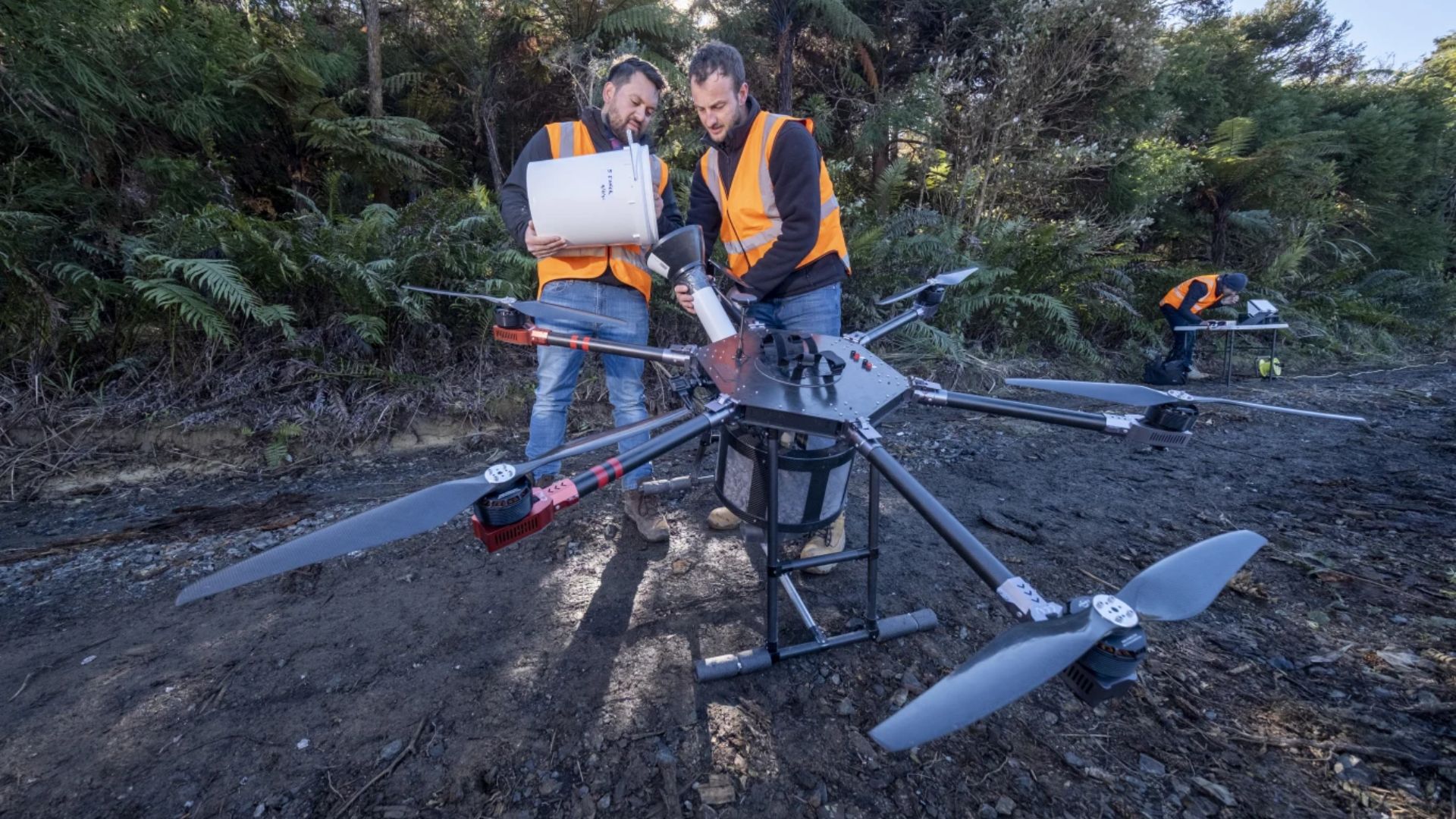 Two people with a large drone.