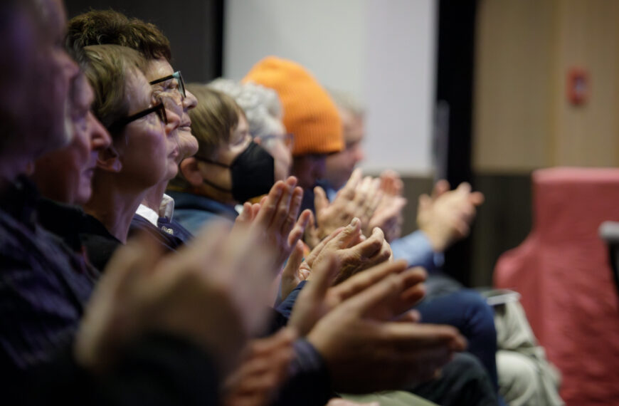 A group of seated people clapping