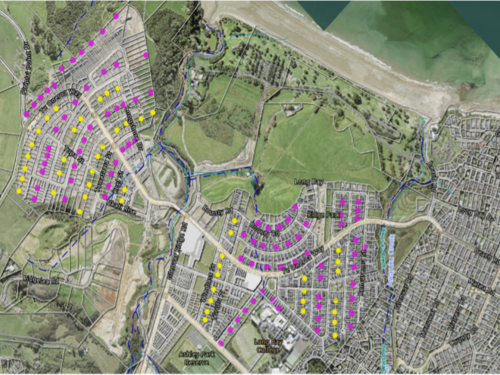 An aerial photograph of a suburb with coloured dots indicating where rat traps will go.