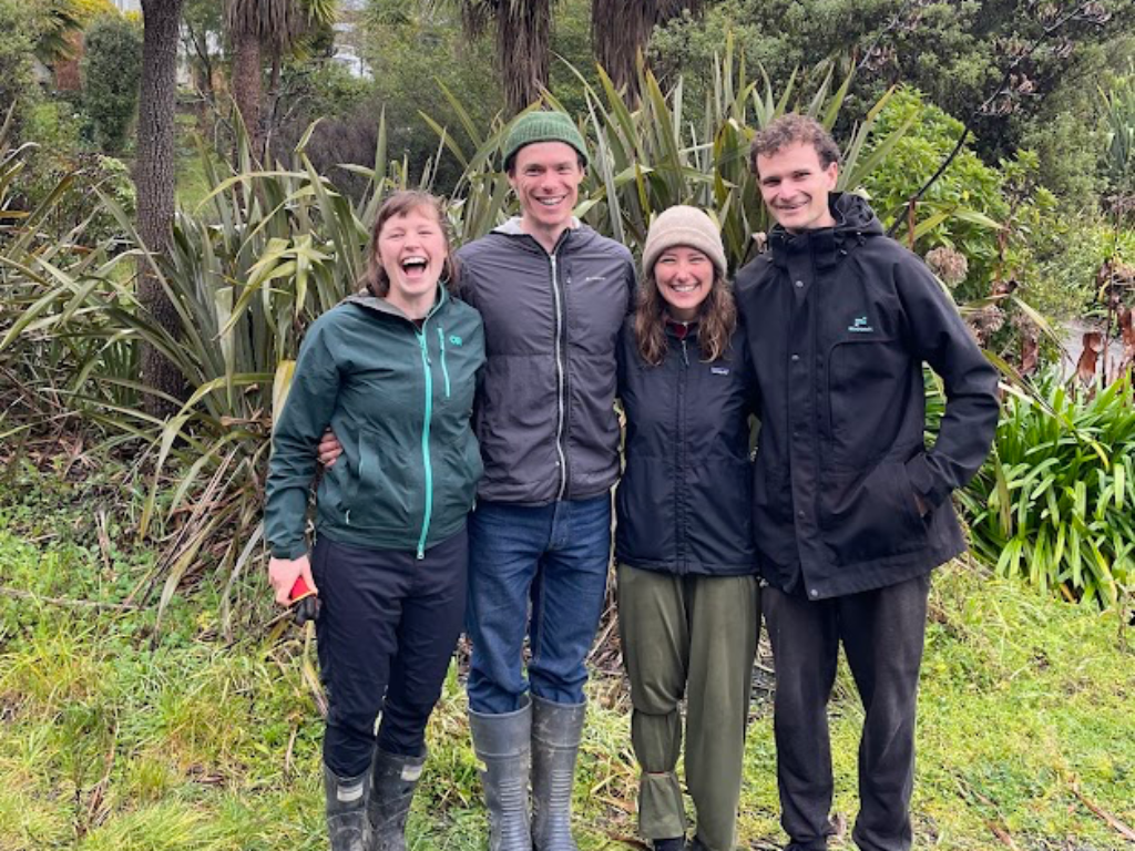 A group of smiling people outside.