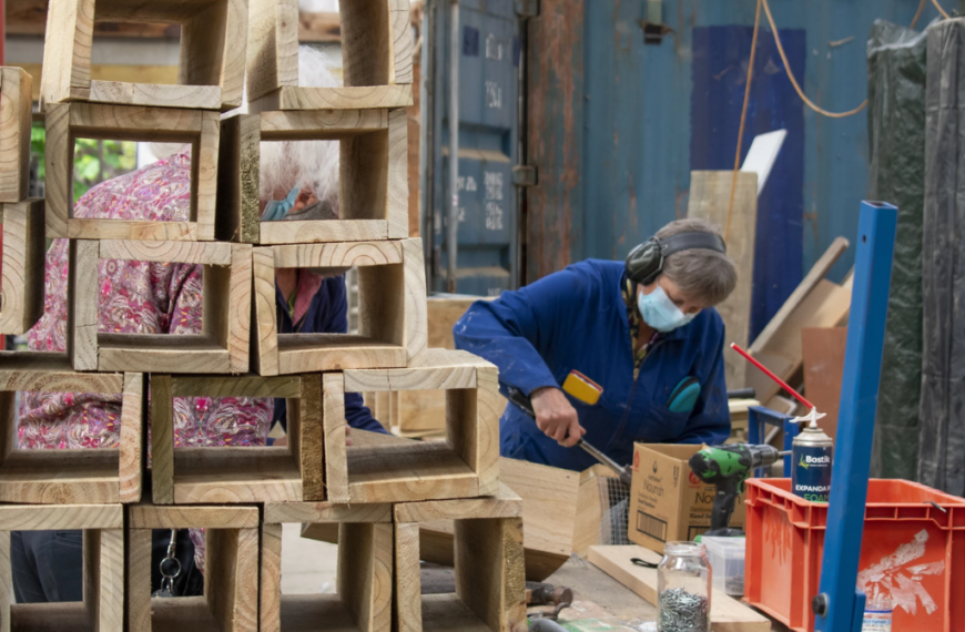 A person in a workshop building trap boxes