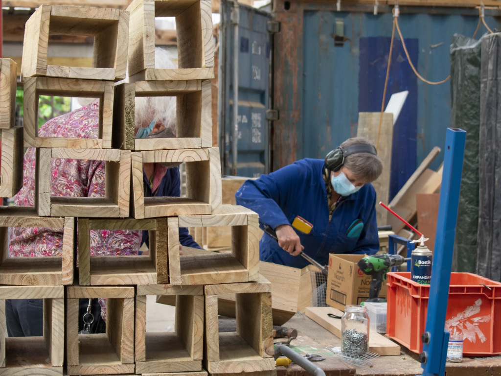 A person in a workshop building trap boxes