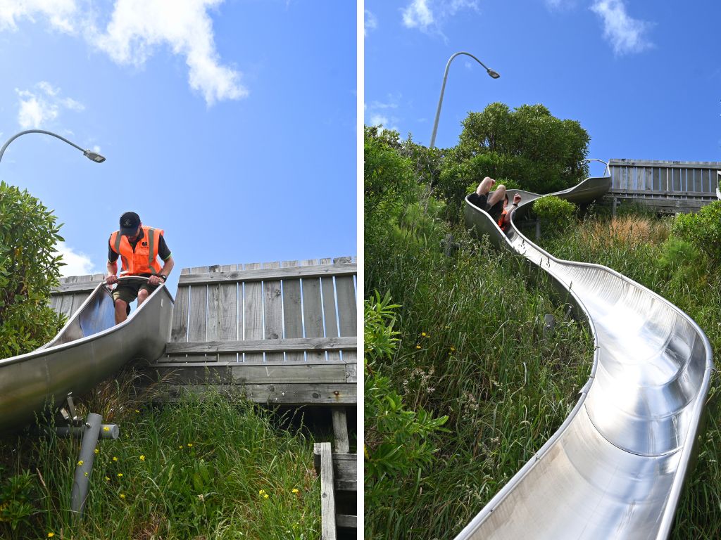 A ranger slides down a big metal slide