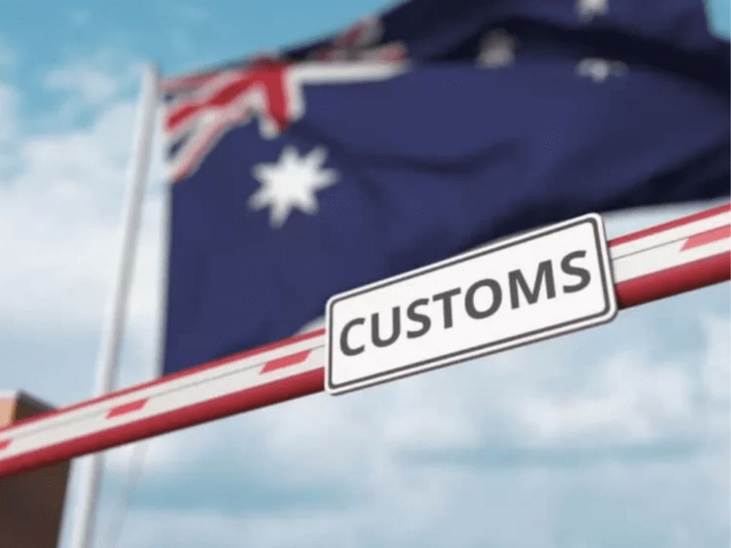 An Australian flag above a customs sign