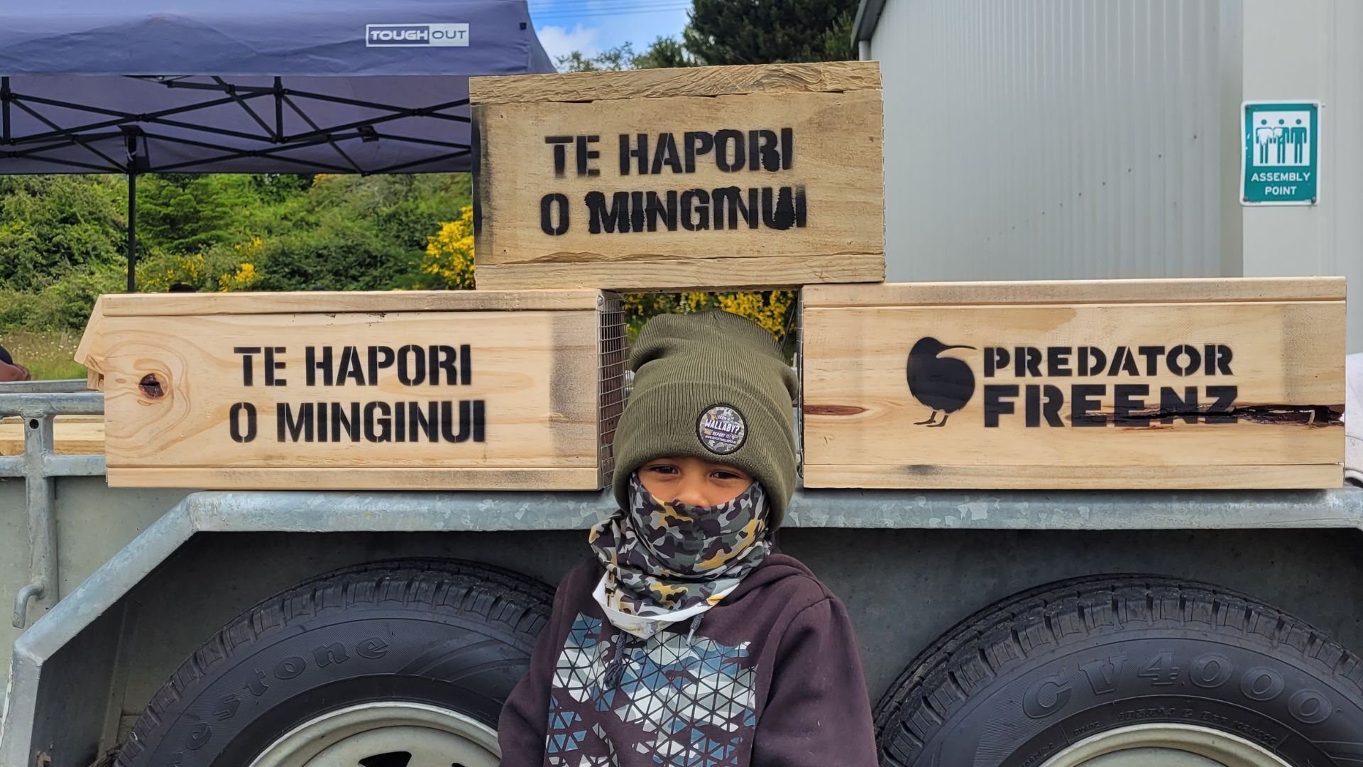 A boy in front of trap boxes