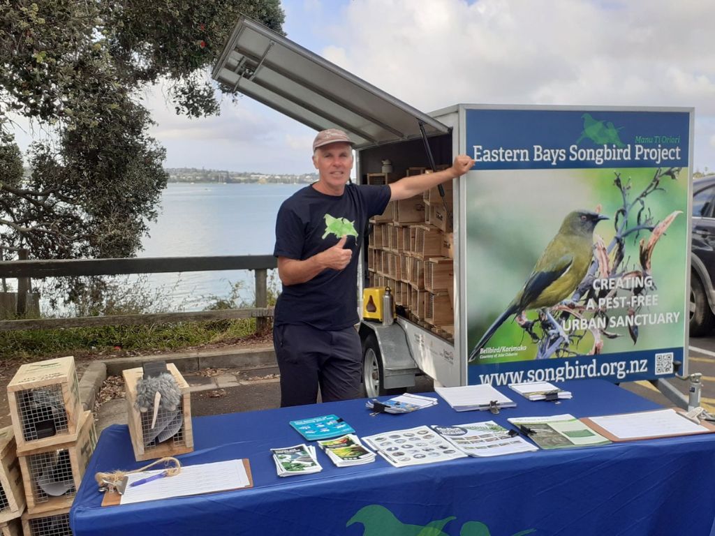 A volunteer giving away free traps at Pt England Reserve.