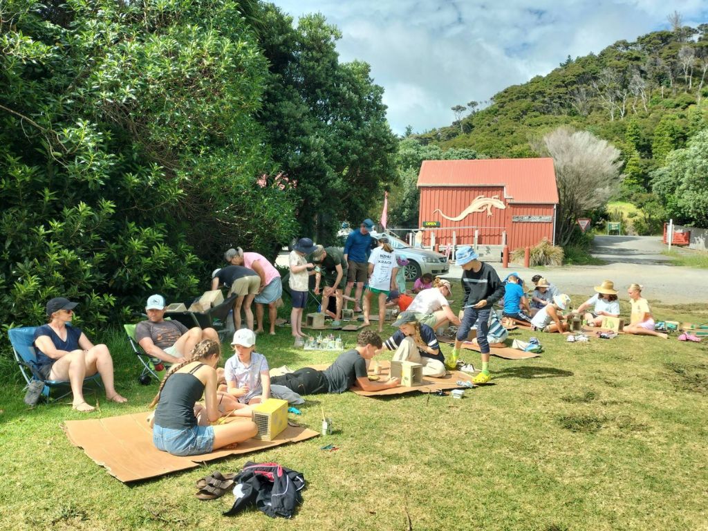 People painting trapping tunnels on a big lawn
